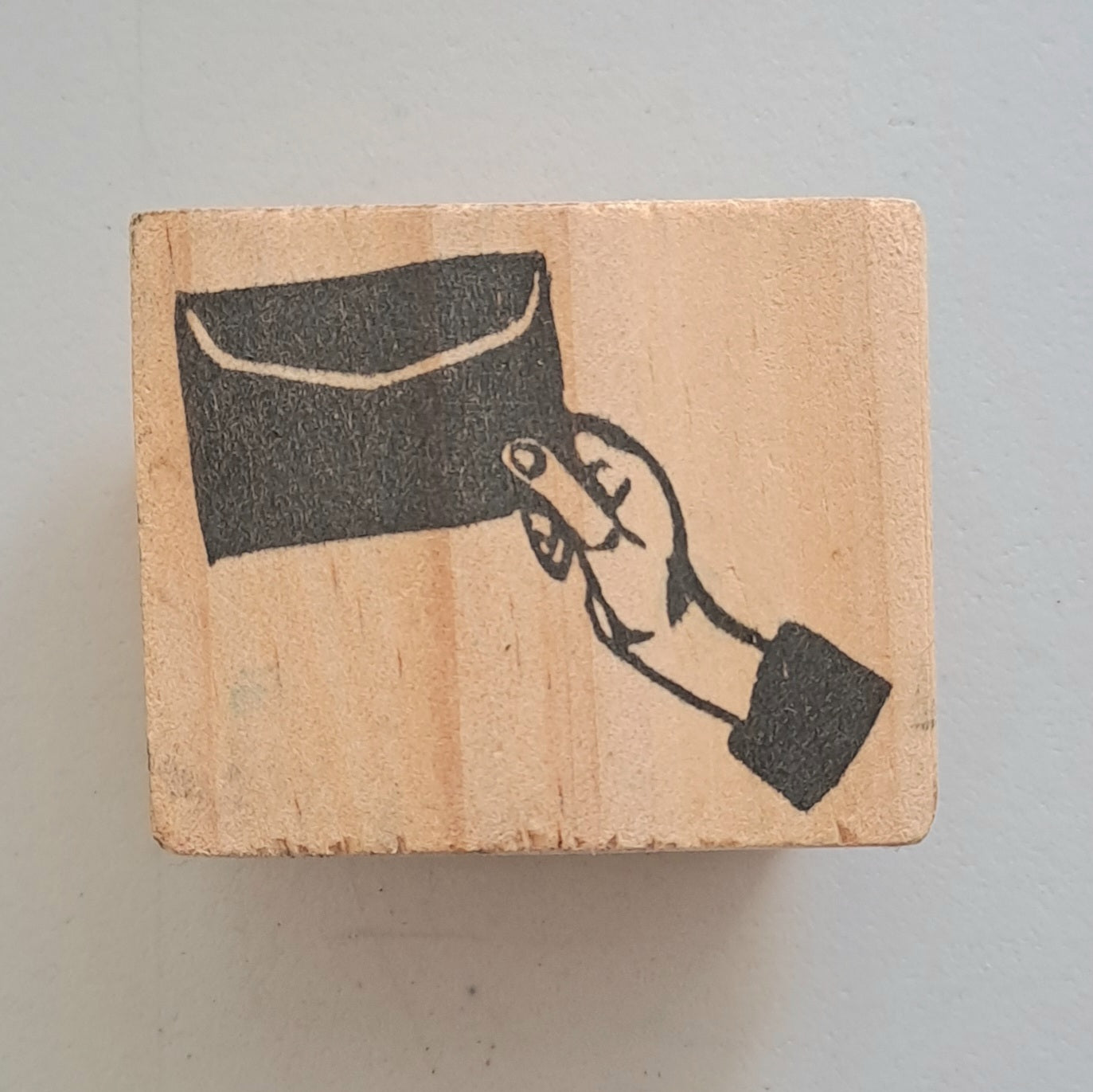 Hand holding an envelope stamp